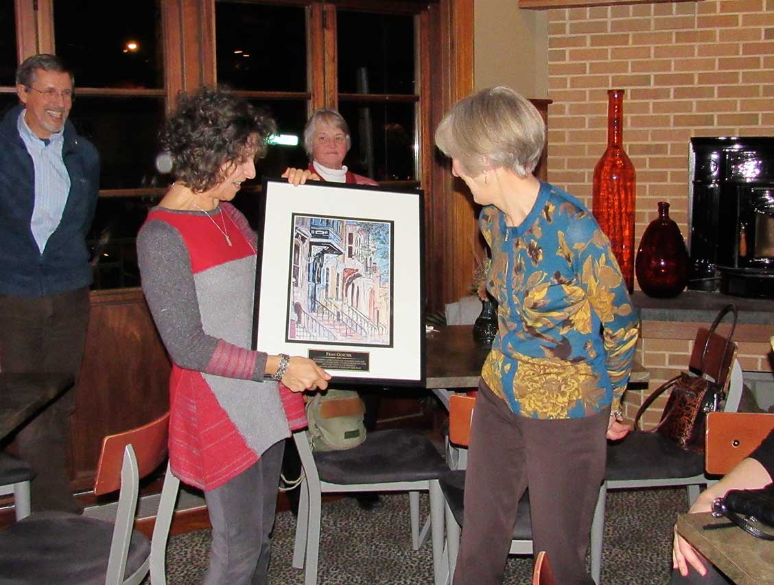 Robin Dropkin presenting Fran Gotcsik an image of Albany's Center Square neighborhood