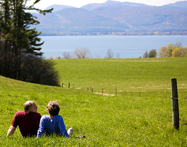 couple-sitting-on-grass-overlooking-water.jpg
